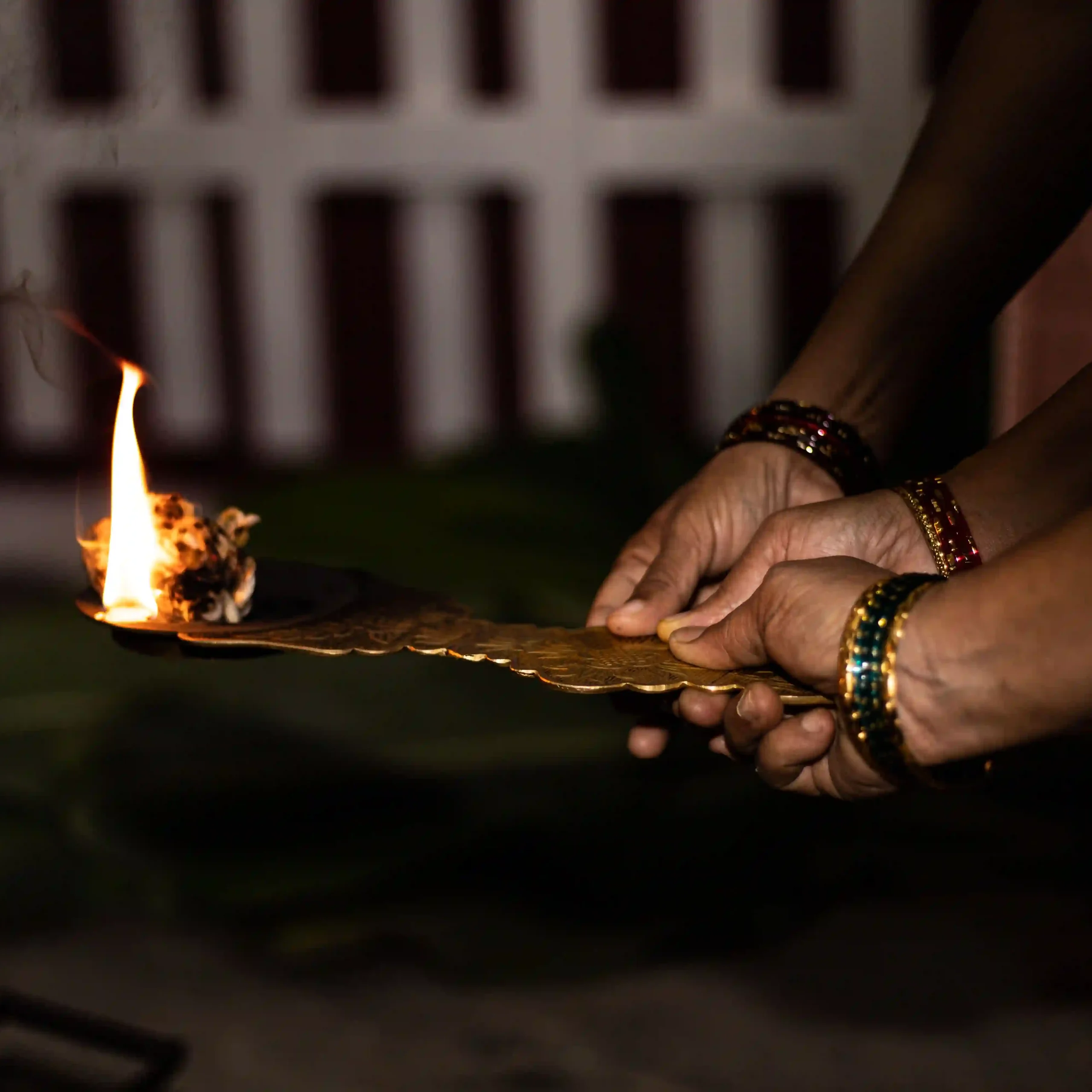 Devotees participating together in a traditional aarti during a spiritual ritual